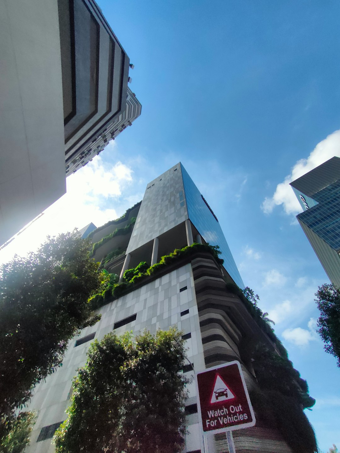 a-very-tall-building-with-a-bunch-of-plants-growing-on-it-au-yerwrmsc